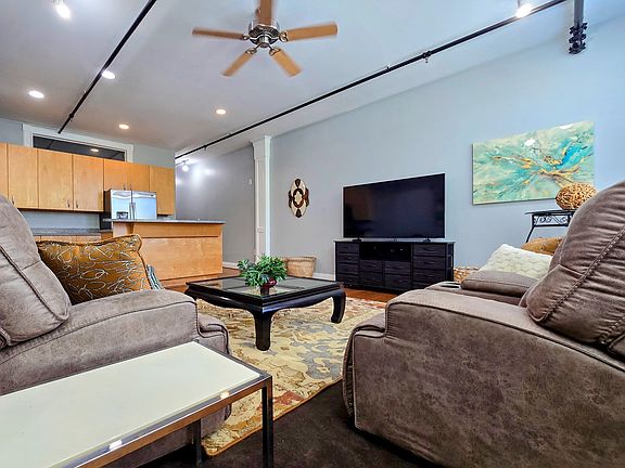 The comfy sofas open to the galley style kitchen