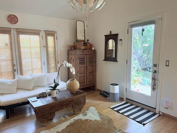 Sofa, coffee table and front door to garden.