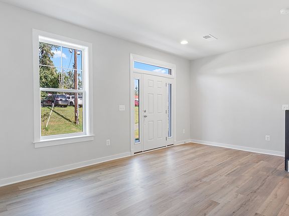 First floor entry with large window, sidelights and transom over front door, recessed lights and woo