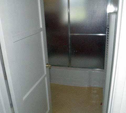 Bathroom, the sink and toilet are out of view behind the doo