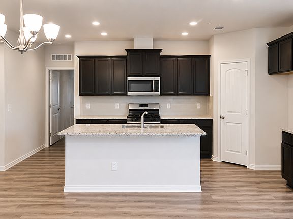 Centered kitchen view with stainless steel appliances