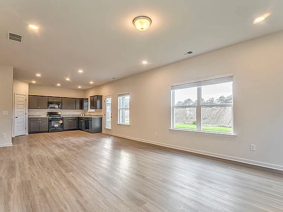 Living & Kitchen - extra recessed lighting and extra windows for natural light - blinds installed on all windows