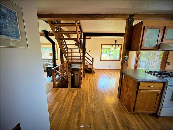 Upon entering you can feel the open space concept with beautiful hardwood floors. Your lower full bath to the left kitchen to the right dining room upper right and living room upper left with your open stairs. 