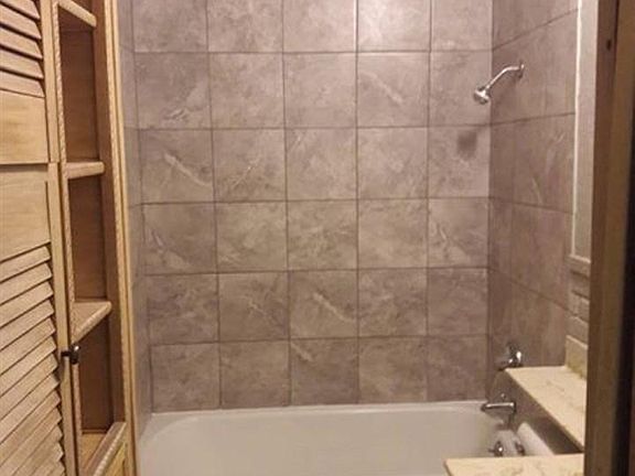 Bathroom is between the two bedrooms with windows facing the front of the house.