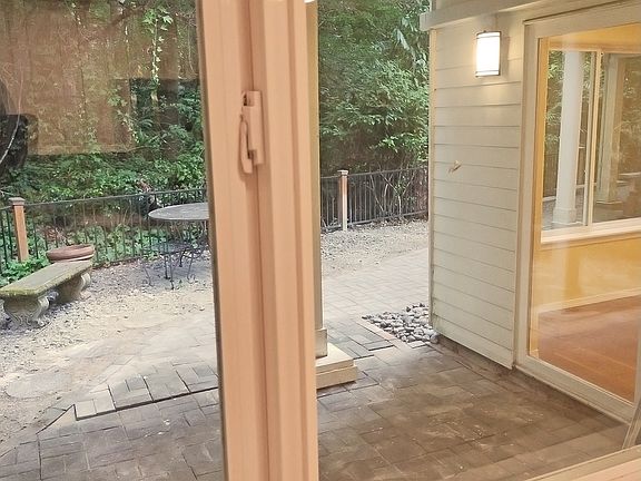 View from your kitchen to the backyard patio area & surrounding greenbelt