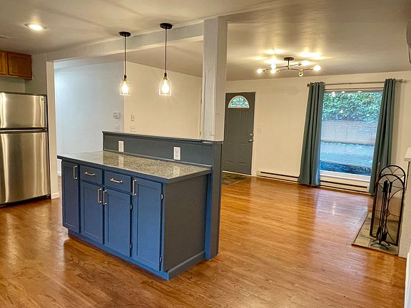 Bright, open concept living/kitchen area with granite tile counter tops. Beautiful hardwoods throughout the house. Super efficient heat pump that is central heat and air conditioning.