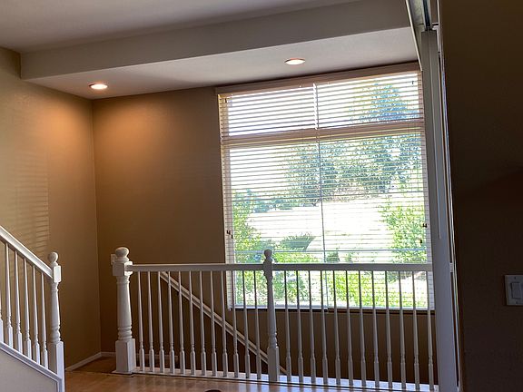 Dining area with a lovely view of greenery and distant mountains that gives off an airy feeling...