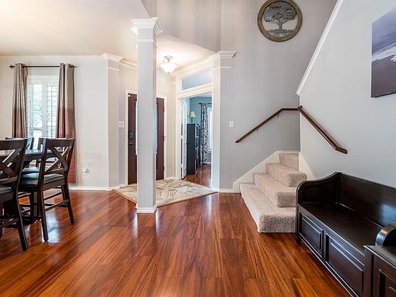 This grand entry is flanked by a formal dining room and private study, along with a custom tile flooring feature at the front door!