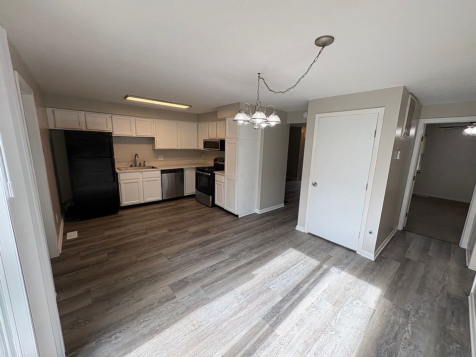 Open concept kitchen with newer countertop, sink and faucet. Numerous kitchen cabinets and pantry cabinet. Fridgerator has ice maker. Garbage disposal.