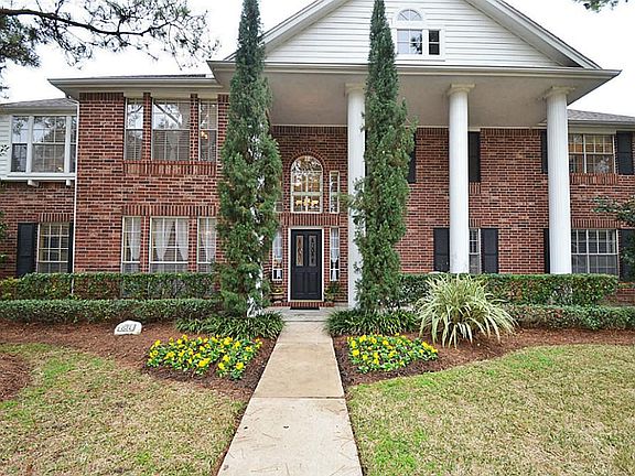 Lush landscaping has a convenient sprinkler system that waters both front and back lawns.
