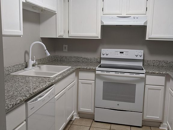 Kitchen with Granite Countertops and freshly painted cabinets.