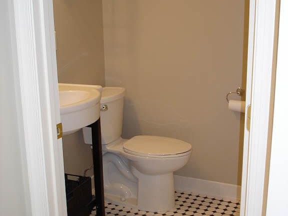 Fully tiled tub/shower/bath off of bedroom.