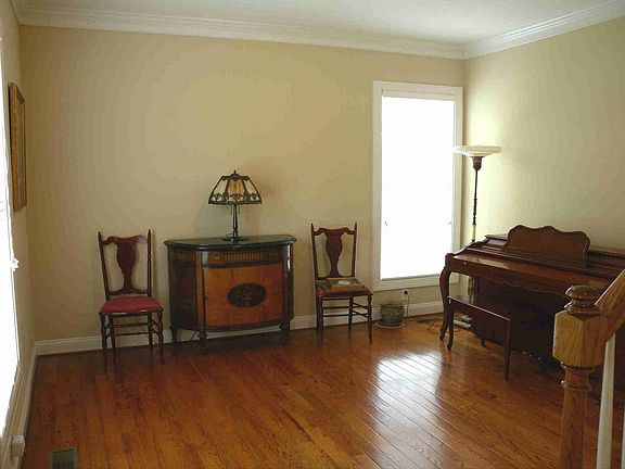 The lovely Formal Living Room with hardwood floor and extensive moldings.