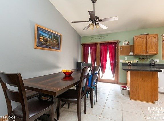 This dining room has plenty of space for a large table and features Vaulted ceiling & sliders to back deck.