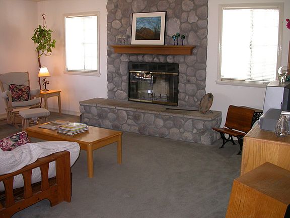 Stone fireplace in living room.