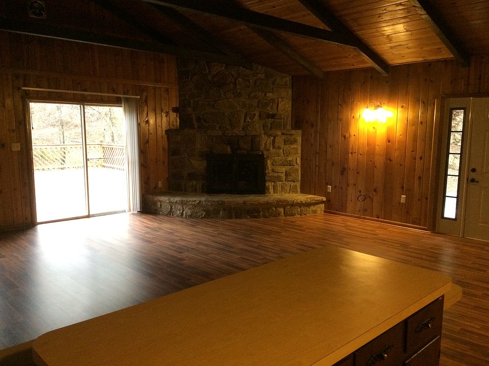 Great room with wood burning fireplace and slider to large d