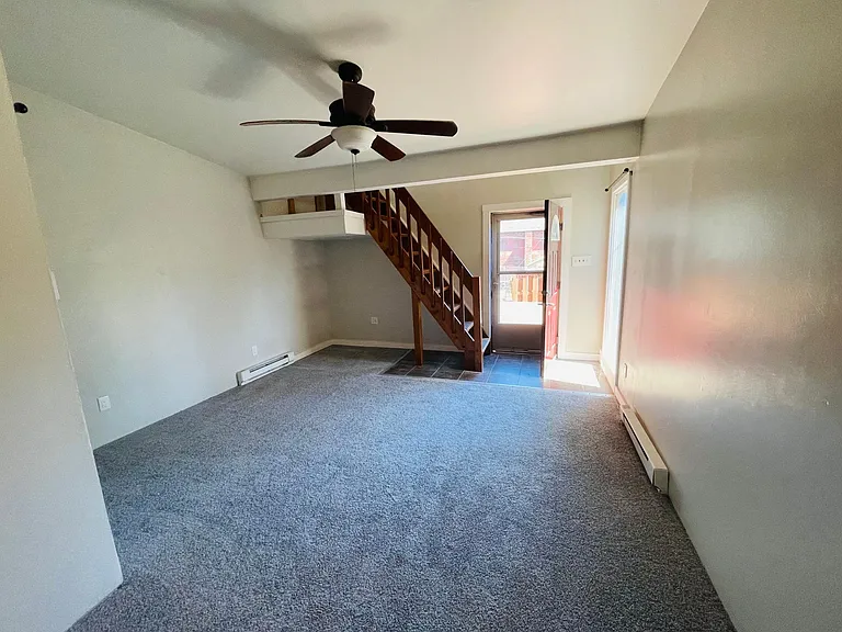 Family room with backdoor to the backyard and porch