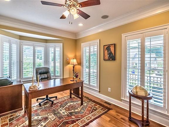 1st Floor Den with lots of natural light! Built in bookcases! Most windows in the home covered with custom plantation shutters! 