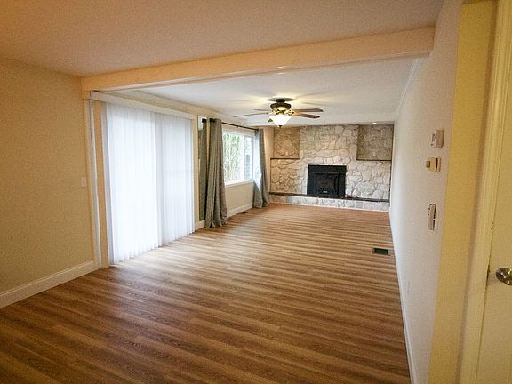 Family den with sliding doors to the back fenced pool area