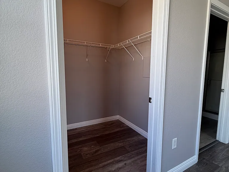 Large walk-in closet in primary bedroom.