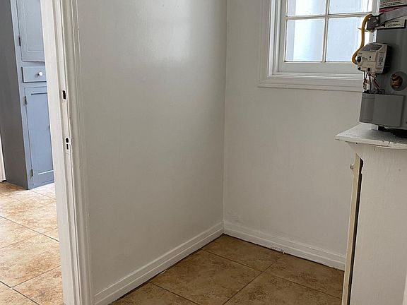 Laundry room area (appliances not included).