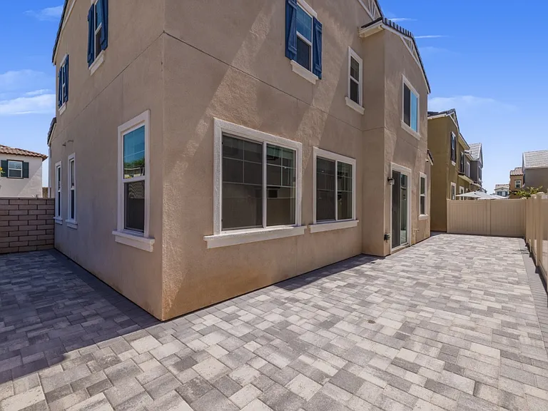 Fully paved side and backyard with modern stone design, perfect for outdoor dining, BBQs, or family gatherings. Enjoy low-maintenance living with a private setting, ideal for relaxing weekends in North Menifee's beautiful "The Village" community.