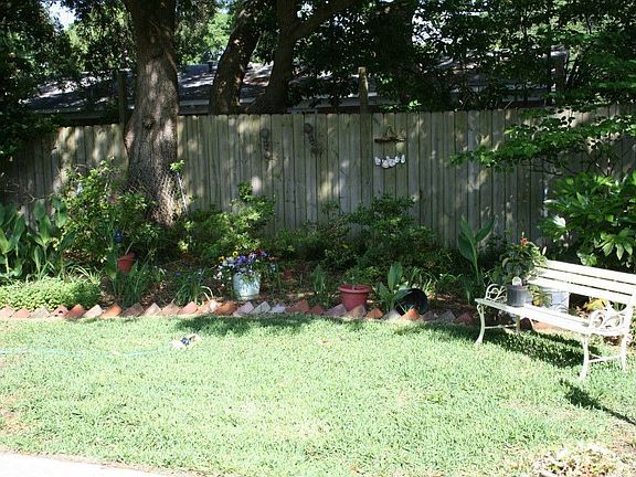 Well Maintained Flower Beds In Back Yard