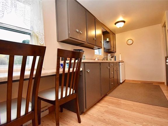 The eat-in kitchen measures 14x9 and includes a breakfast bar overlooking the back yard.