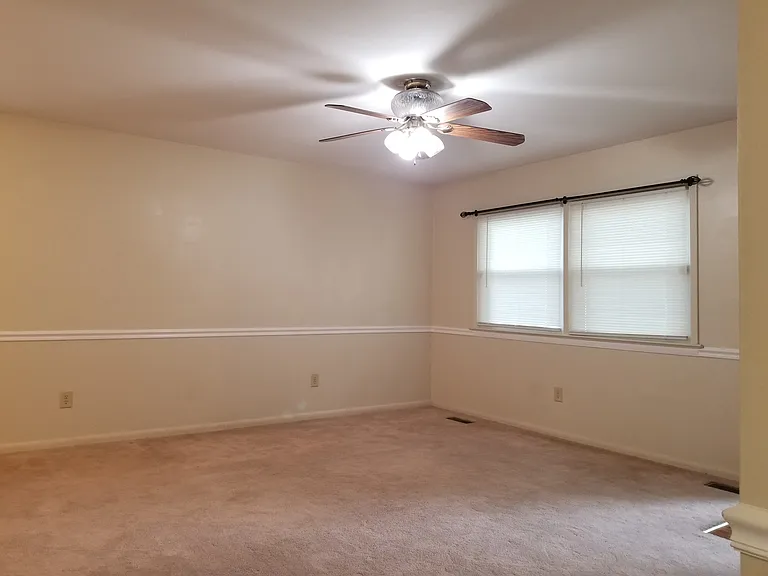 Living room from end of hallway.
Front door entrance on right side.
Dining room and kitchen on left.