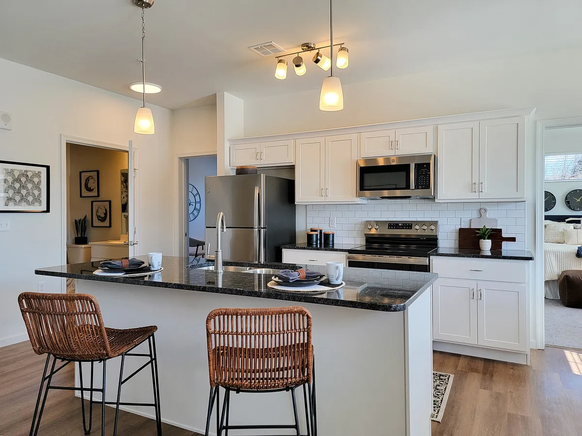 Kitchens at RedMill Crossings offer modern appliances, an island sink and breakfast bar. - RedMill Crossings