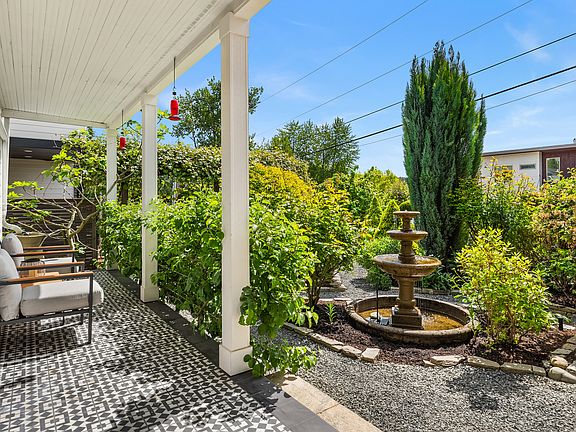 The old-world-inspired front garden features a water fountain, espaliered apple tree, Concord grapevine and fig tree.