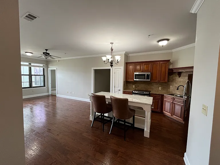 Bright, open-concept living room and gourmet kitchen, beautifully showcased from the front door entry, creating an inviting sense of luxury from the moment you walk inside.