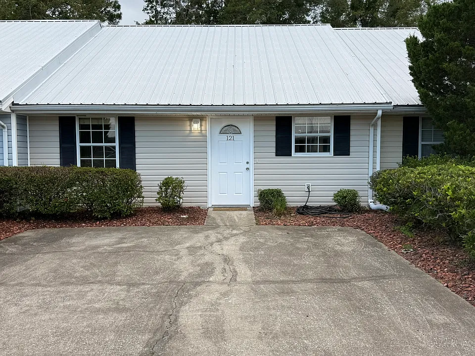 Condo 121 is on the first floor with a private driveway for up to two cars. Street bedroom on the left and to the right is the kitchen.