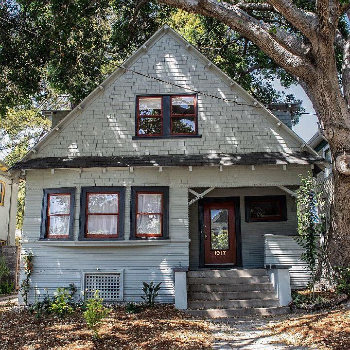Front of house covered with ancient California oak tree