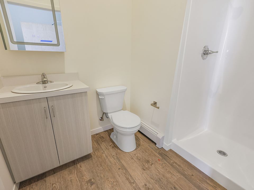 Bathroom with shower and lighted mirror