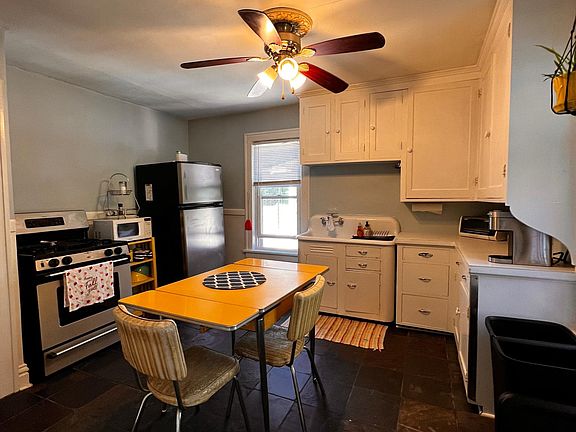 Light filled kitchen with nice appliances, slate floors and good cabinet space