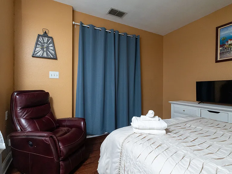 Cozy and inviting bedroom featuring a tufted headboard and warm, earthy tones.