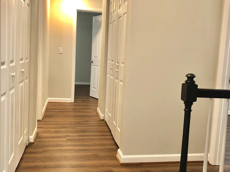 Upstairs hallway with laundry to the right and storage to the left