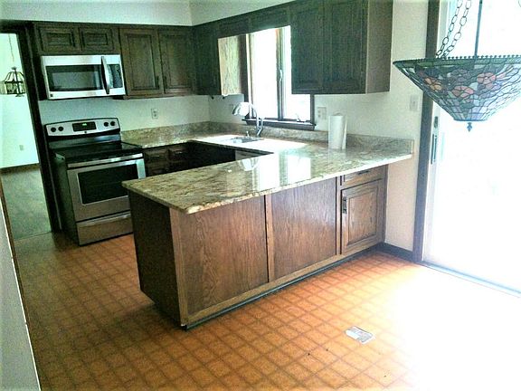 Kitchen with granite and stainless appliances.