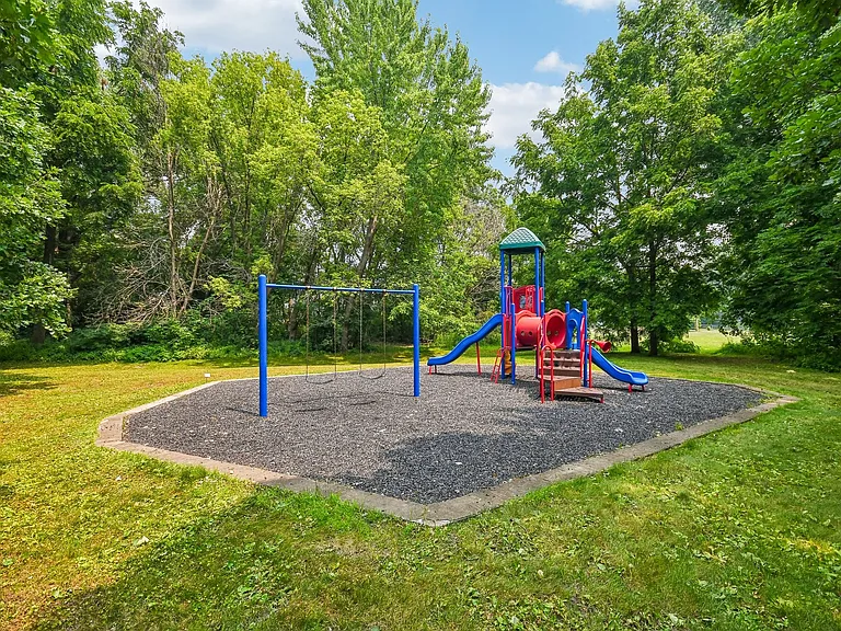 Mill Pond Apartments features a vibrant playground surrounded by lush greenery, perfect for family fun and outdoor activities. Enjoy ample space for relaxation and recreation right at your doorstep. Explore your new home today!