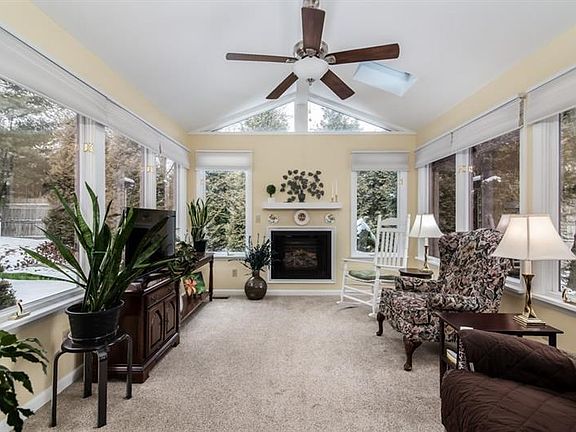 Four Seasons Room, with vaulted ceiling, skylights, gas fireplace and walls of windows with blinds to help shade those sunny day