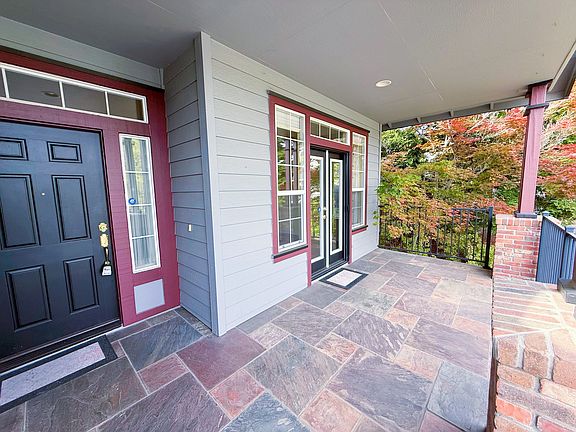 Huge front covered porch with main front door and another double door access from living room.
