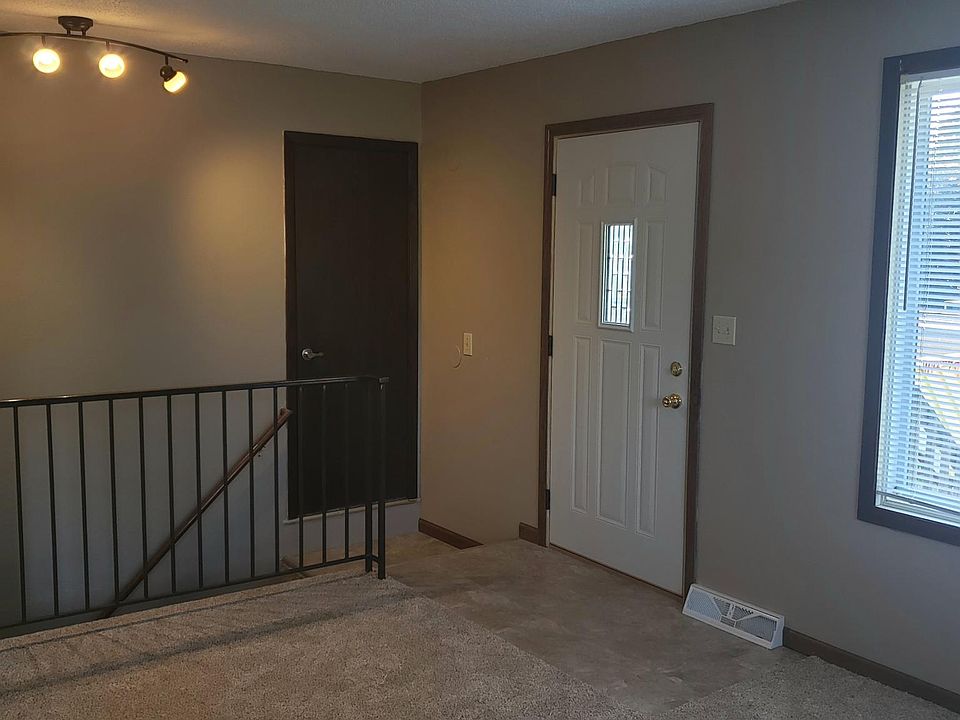 Front entrance to living room. Stairs to lower level.