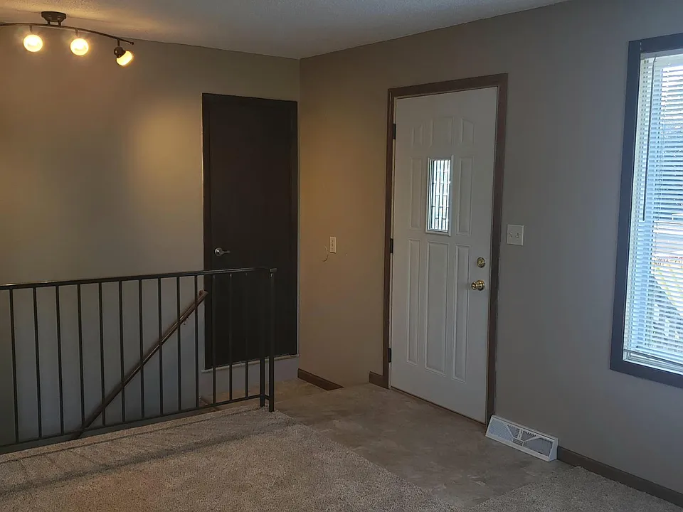 Front entrance to living room. Stairs to lower level.