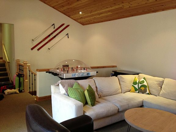 Living room area with bubble hockey and Pac Man video game