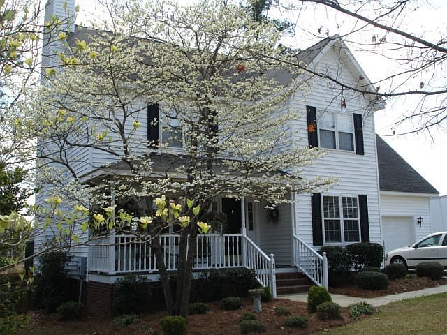 Front with Blooming Dogwood, Fenced Backyard