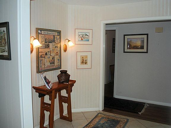 Spacious tiled foyer, room for your favorite furniture, access to living space and bedroom hallway.