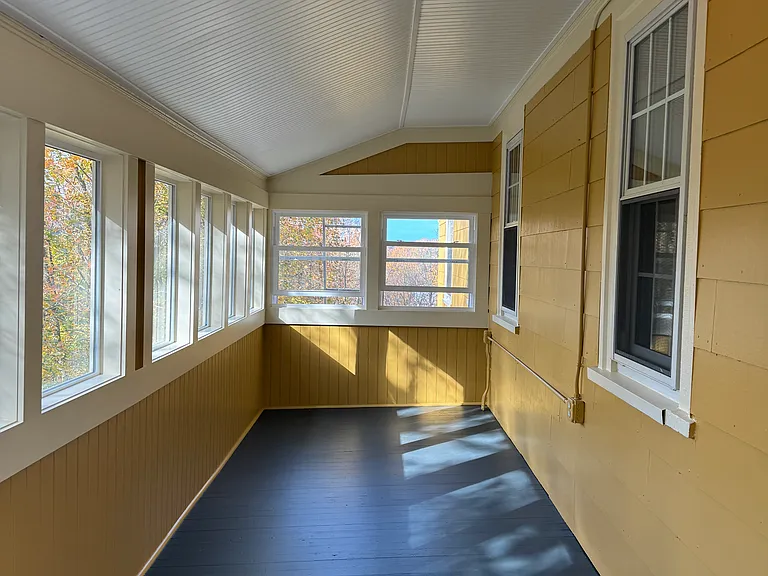 This alluring three season L-shaped back porch is an AMAZING sanctuary area with endless creative possibilities. This bonus area has an impressive glorious view of the city and beyond from this back porch!