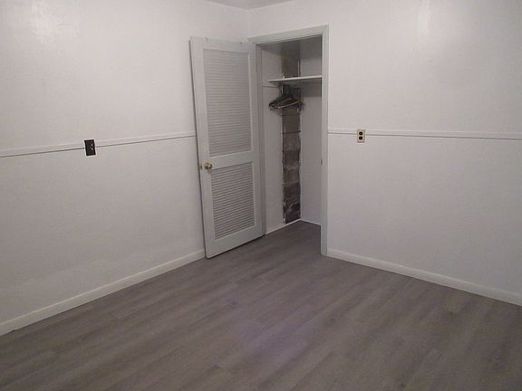closet in corner of one bedroom