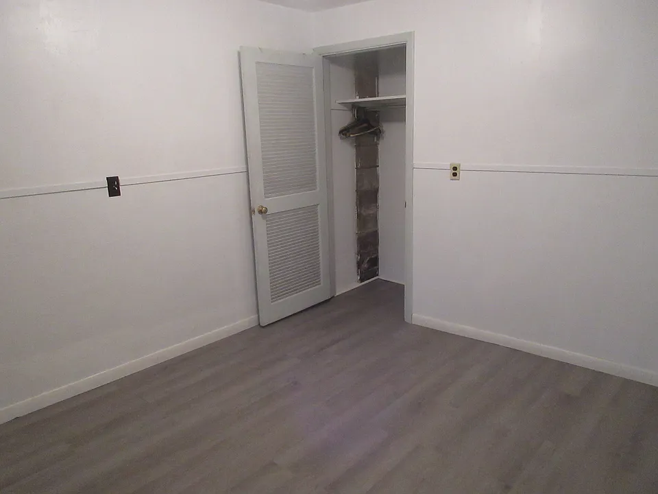 closet in corner of one bedroom